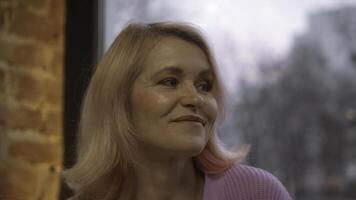 Close-up of beautiful elderly woman listening and talking. Stock footage. Beautiful elderly woman is talking on date in cafe. Woman talks and listens on date in cafe photo