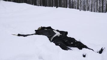 Man lies in white snow in winter. Media. Man lies and rests on winter snow in forest. Man is resting or sleeping in snow on winter day photo