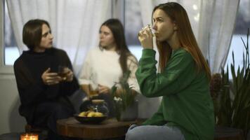 Students talk and relax in cozy cafe. Media. Beautiful young woman is drinking tea on background of talking couple. Students relax and drink tea in college cafe photo