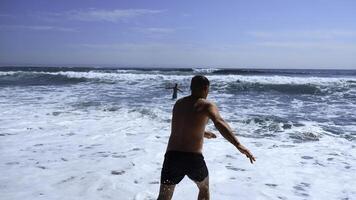 People bathe in beautiful blue waves on sunny day. Clip. Beautiful blue waves with foam on shore with vacationing people. People in swimsuits swim with blue waves of sea on summer day photo