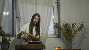 Young woman romantically drinks tea in cafe. Media. Young female student is relaxing in cafe with tea. Beautiful young woman is drinking tea alone in cozy cafe photo