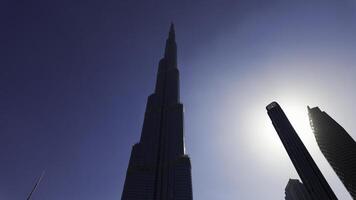 A low angle view of the skyscrapers in the centre of Dubai. Action. Concept of modern architecture. photo