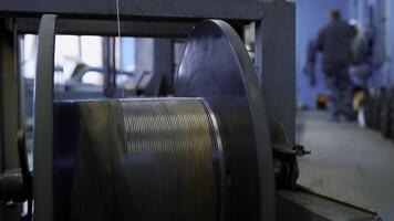 Close up of automated winding the cable on the drum. Creative. Industrial cable production factory. photo