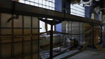 View inside of a workshop of an old fashioned factory. Creative. Long pipe stretching along the wall, industrial equipment. photo