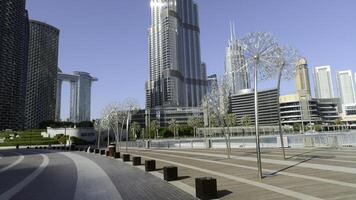 Low angle view of Burj Khalifa in Dubai, UAE. Action. The tallest building in the world and famous tourist attraction, city on a summer day. photo