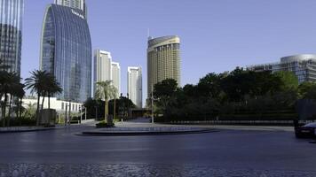 DUBAI - UAE, APRIL 3, 2023. Modern city architecture in Business bay district on a sunny day. Action. Dubai skyscrapers and fountain photo