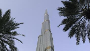 Low angle view of Burj Khalifa in Dubai, UAE. Action. The tallest building in the world and famous tourist attraction, city on a summer day. photo