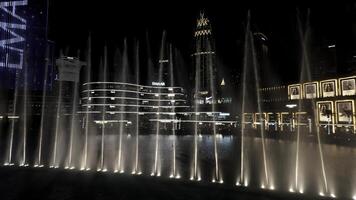 Dubai - UAE, February 17, 2023. colorful fountain show at night. Action. Beautiful city street with lights illumination. photo