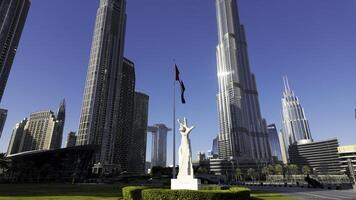 Monument with hand gesture designating win, victory, love. Action. Dubai, UAE, architecture and waving flag. photo