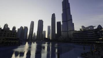 Dubai - United Arab Emirates, January 23, 2023. Hotels of Dubai city. Action. Blue cear water of the city fountain. photo