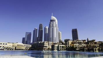 Dubai - United Arab Emirates, January 23, 2023. Panoramic view of Downtown Dubai with Address Downtown Hotel. Action. Hot sunny day with blue clear sky in the city. photo