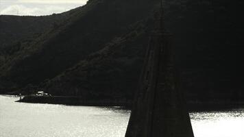 Ancient tower with beautiful river and green mountains behind. Creative. Concept of architecture. photo