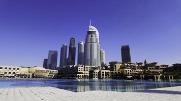 Dubai - United Arab Emirates, January 23, 2023. Panoramic view of Downtown Dubai with Address Downtown Hotel. Action. Hot sunny day with blue clear sky in the city. photo