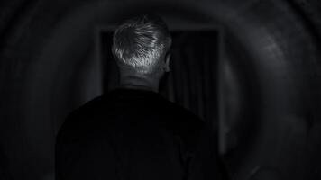 Rear view of a young rapper performer feeling anxiety before going on stage. Media. Man in a corridor with the effect of spinning walls. photo