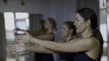 Side view of young ladies starting workout at the gym. Media. Concept of body care and fitness. photo