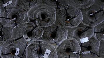 Close up of stack of rolls at the industrial plant. Creative. Insulation rolls with cables. photo