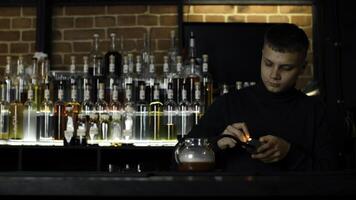 Bartender making unusual cocktail in a tea pot at the bar. Media. Adding smoke into the hot cocktail. photo