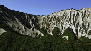 Beautiful aerial of the white cliffs on the south coast of England. Clip. Green summer forested hills and blue sky. photo