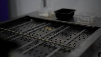 Close up of automated conveyor belt at a factory. Media. Empty conveyor belt and small plastic boxes. photo