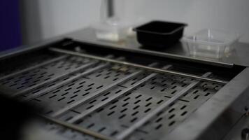 Close up of automated conveyor belt at a factory. Media. Man hands putting plastic small boxes on empty conveyor belt. photo