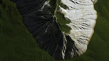 Top view of picturesque mountain peak. Clip. Frozen stone formations and green grass. photo