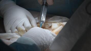 Surgery operation close up. Action. Hands of a doctor making an injection during procedure. video