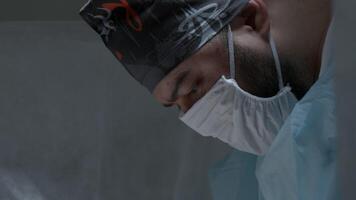 Facial portrait of a doctor. Action. Concentrated doctor's face during operation. video