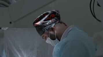 Portrait of a surgeon preparing for the procedure at work in a hospital. Action. Sterile operating theatre. video