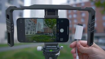 Professional shooting on phone with memory card. Action. External disk for recording material from phone. Shooting on phone with stabilizer and external memory video