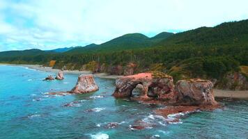 Top view of amazing cliffs of sea coast. Clip. Rocks with erosion of sea waves create amazing stone arches. Beautiful rocky arches on seashore video