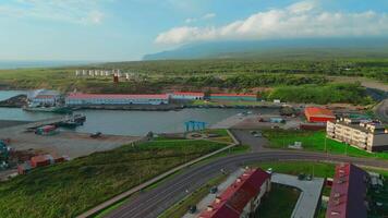 Top view of sea port with sand on north coast. Clip. infrastructure of seaport on seashore. Beautiful landscape of village with seaport on coast of mountain coast video