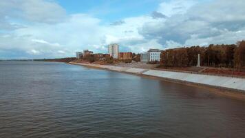 Top view of river embankment of city with forest. Clip. Landscaped embankment of city river bank. Beautiful landscape of river embankment with city park video