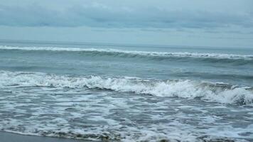 Seascape of beautiful waves on cloudy day. Clip. Beautiful coastal waves on background of horizon with cloudy sky. Coastal waves of North Sea on cloudy day video