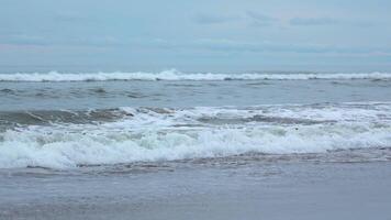 Seascape of beautiful waves on cloudy day. Clip. Beautiful coastal waves on background of horizon with cloudy sky. Coastal waves of North Sea on cloudy day video