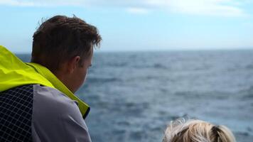 Paar auf schwebend Boot auf Hintergrund von Meer. Clip. zwei Menschen sind Segeln auf Schiff mit Meer Sicht. Paar auf Meer Reise auf Schiff auf Hintergrund von Meer Horizont video