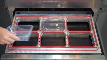 Production of plastic packages, industrial background. Media. Close up of conveyor belt with plastic small boxes. video