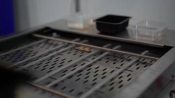 Close up of automated conveyor belt at a factory. Media. Empty conveyor belt and small plastic boxes. video