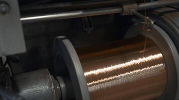 Rotating coils with metal wires at factory. Creative. Winding of metal fiber on bobbins at metallurgical plant. Process of twisting into coils of copper wire on industrial scale video