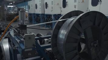 Close up of slowly rotating big bobbin with winding thin metal sheet. Creative. Industrial background at the plant. video