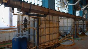 View inside of a workshop of an old fashioned factory. Creative. Long pipe stretching along the wall, industrial equipment. video