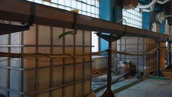 View inside of a workshop of an old fashioned factory. Creative. Long pipe stretching along the wall, industrial equipment. video