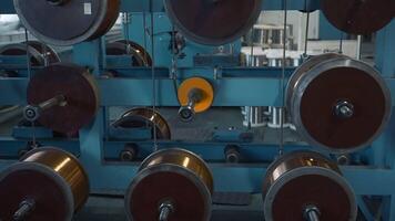 Furniture cable manufacturing equipmet workshop. Creative. Industrial metal plant with spinning bobbins. video