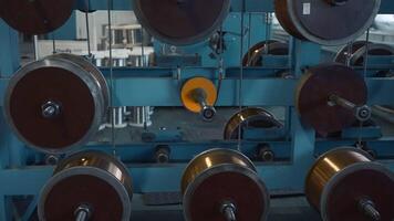 Furniture cable manufacturing equipmet workshop. Creative. Industrial metal plant with spinning bobbins. video