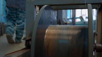 Cable factory interior details. Creative. Winding of the electrical cable to the bobbin in the production. video