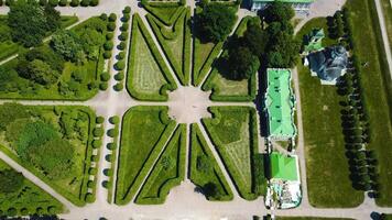 Top view of royal garden with patterns and ancient buildings. Creative. Amazing beauty of garden pattern and trails of royal palace. Territory of old rich estate with garden on sunny summer day video