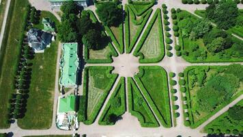 Top view of royal garden with patterns and ancient buildings. Creative. Amazing beauty of garden pattern and trails of royal palace. Territory of old rich estate with garden on sunny summer day video