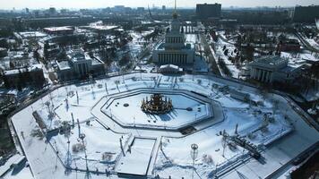 Top view of round square in winter. Creative. Beautiful historical square with fountain on sunny winter day. Sovetskaya Square with architecture and square in city center video