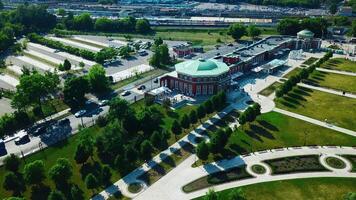 Top view of historic building with garden patterns on sunny day. Creative. Landscape design of garden with patterns near historic building. Historical complex with garden on background of modern city video