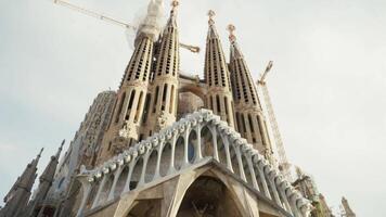 Basilica and Expiatory Church of the Holy Family, Barcelona - Spain. Stock. Facade view of Birth at Sagrada Familia Temple from Gaudi Square in Barcelona city video