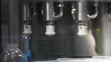 Liquid detergent on automated production line. Clip. Machinery for bottling video